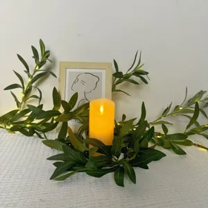 Artificial olive leaf wreath with LED candle detail, perfect for home tabletop decor setup.