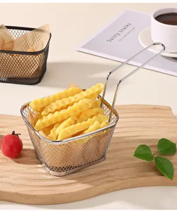 Detail view of mini stainless steel wire mesh frying basket with crinkle fries on wooden board.