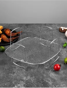 Stainless steel square air fryer rack detail shot, showing mesh grid and vertical handle design.