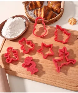 Red plastic Christmas cookie cutter set, baking molds for holiday biscuits and pastry.