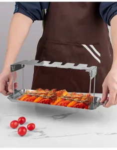 Stainless steel folding chicken leg roasting rack with drip tray for outdoor BBQ and home cooking.