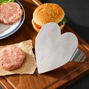 Stainless steel heart shaped burger press patty maker kitchen tool for making delicious meat patties.