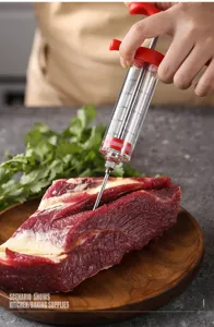Detailed view of meat marinade injector syringe with clear scale markings for BBQ and cooking.