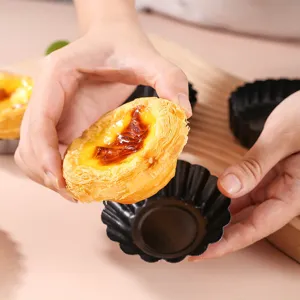 Black non-stick carbon steel fluted egg tart pan and pie mold for home baking and oven use.