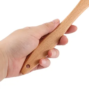 Wooden handle kitchen spatula grip close-up view showing natural beech wood texture and hole.