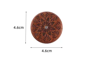 Wooden UFO bread lame detail, engraved mandala pattern, compact scoring tool design.