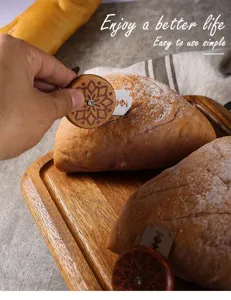Wooden UFO bread lame detail shot, ergonomic round handle with sharp stainless steel blade.