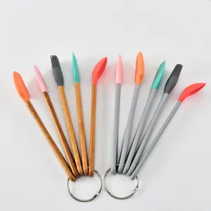 Colorful silicone mini baking tools set with wooden and plastic handles for kitchen use.