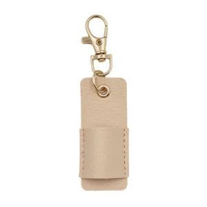 Leather pen holder keychain detail view, portable stationery accessory in beige color.