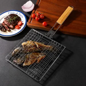 Stainless steel foldable fish grilling basket with wooden handle for outdoor barbecue cooking.