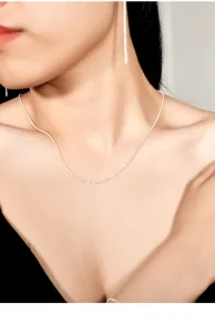 Close-up detail view of sterling silver sparkling starlight clavicle necklace worn.