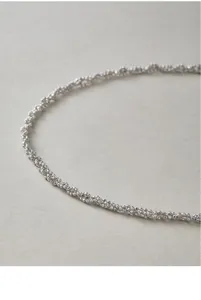 Close-up detail of sterling silver sparkling bead woven necklace showcasing exquisite texture.