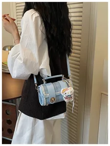 Stylish blue plaid handbag detail, fashion color-block commuter shoulder bag with cute plush charm.