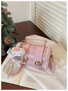Pink tweed Boston handbag with lace trim, top handle and plush bear pendant detail.