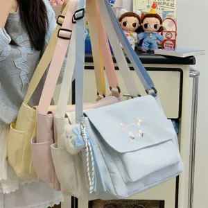 Large capacity canvas messenger bag for women, stylish casual crossbody tote bag with cute embroidery.
