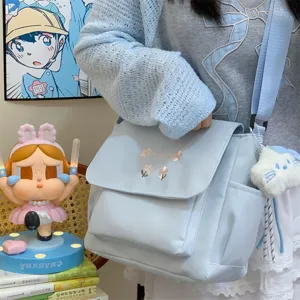 Light blue casual shoulder bag with floral embroidery, large capacity commuting messenger bag for women.