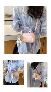 Chic pink pillow shoulder bag for women, stylish crossbody bag with cute floral pearl charm.