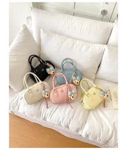 Detailed view of trendy women bowling handbags with cute bear pendants in multiple colors.