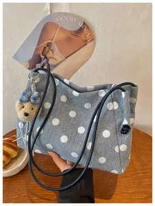 Detailed view of the casual denim polka dot shoulder bag with cute bear charm and daily use.