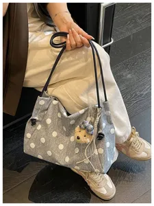 Casual polka dot shoulder bag for women, large capacity commuter tote with cute bear charm.