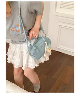 Light blue bowling shoulder bag with cute charm, stylish commuting handbag for women.