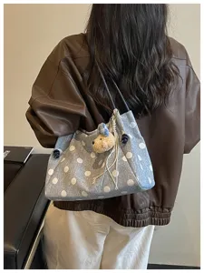 Casual polka dot shoulder bag for women, large capacity stylish tote bag for daily commute.