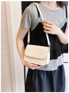 Close-up detail of minimalist women's crossbody bag featuring clean lines and smooth leather texture.
