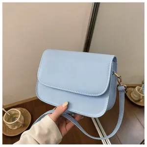Detailed view of the stylish light blue crossbody bag, showcasing its elegant minimalist design.