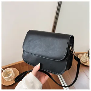 Minimalist black crossbody shoulder bag for women, chic PU leather daily handbag with strap.