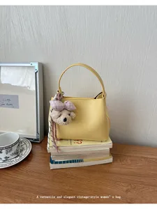 Yellow women handbag vintage style chic hand bag with cute bear pendant for daily commute.