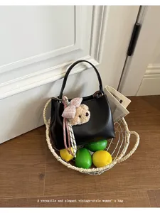 Elegant black bucket handbag featuring a cute plush bear charm and bow, perfect for daily wear.