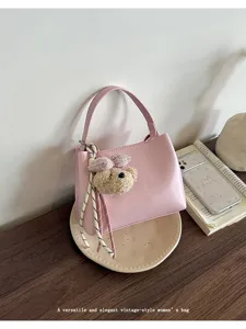 Pink leather women handbag with cute bear charm, elegant vintage shoulder bucket bag.