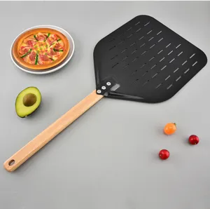 Detailed view of the 12-inch perforated pizza peel with long wooden handle for baking.