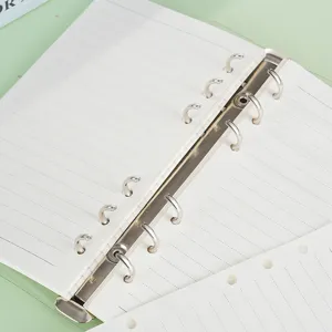 Loose-leaf ring binder notebook with lined paper, metal multi-ring mechanism, stationery.
