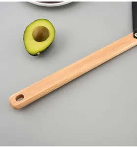 Ergonomic wooden handle pizza peel detail shot, durable kitchen baking tool for home use.