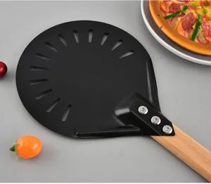 Stainless steel pizza peel with perforated design and wooden handle, detailed view.