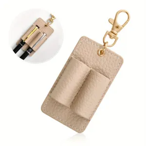 Portable leather double pen holder keychain in beige, featuring durable gold metal hardware.