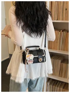 Stylish black and white plaid Boston handbag with top handle and chic charm, ideal for daily commuting.