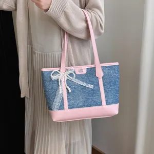 Casual denim tote shoulder bag for women, stylish large capacity handbag with bow detail.
