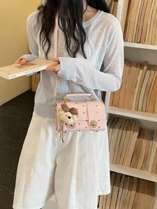 Pink polka dot crossbody bag for women, stylish Boston handbag with cute bear pendant for summer.