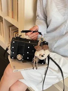 Black polka dot crossbody bag with cute bear pendant, stylish shoulder handbag for women main view