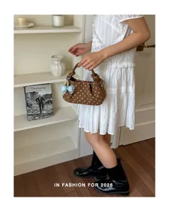 Sweet polka dot handbag for women, trendy summer shoulder bag with cute bow pendant.