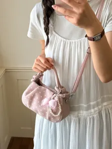 Chic pink polka dot crossbody bag with pearl bow pendant, stylish daily shoulder purse.