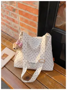Vue détaillée du sac cabas en toile à pois blancs avec charmant pendentif ours mignon.