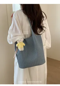 Korean style blue woven shoulder tote bag with cute bear charm for women daily commute use.