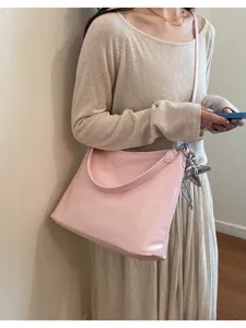 Pink shoulder bag for women, lightweight commuter tote with stylish star pendant design.