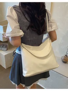 Minimalist white shoulder tote bag detail shot, lightweight daily commute bag for women.