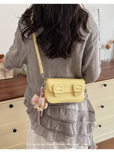 Yellow PU leather crossbody small square bag with double buckle flap and cute bear pendant.