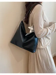 Detailed view of the stylish black PU leather shoulder tote bag with silver star pendant.