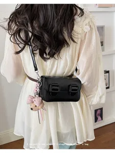 Chic black vintage style women shoulder crossbody bag with cute bow bear pendant detail.